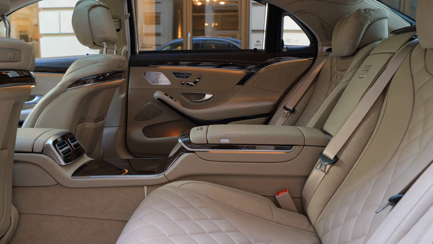 An empty ivory leather cabin with generous space and warm wood trim
